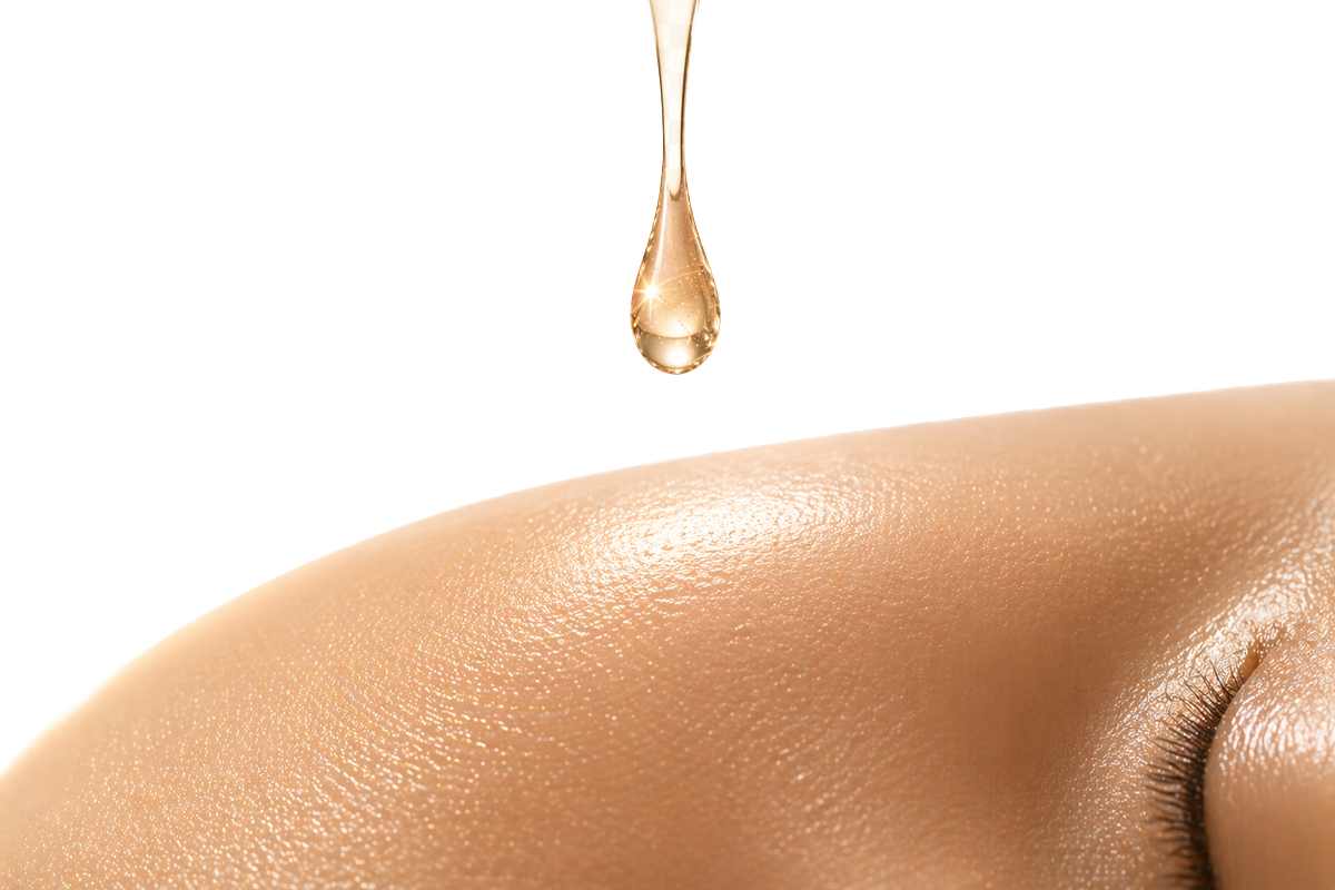 Golden serum droplet on glowing skin